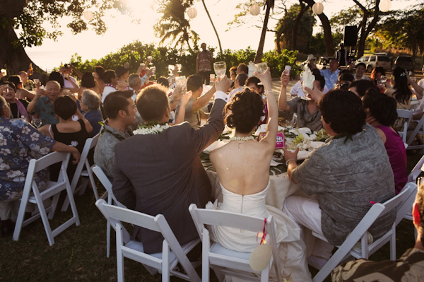 outdoor wedding reception - guests toasting - photo by Hawaii based wedding photographer Derek Wong